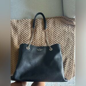 Kate Spade black purse with gold chain straps. Worn but in good condition
